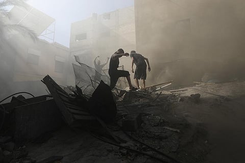 FILE - Palestinians look for survivors under the rubble of a destroyed building following an Israeli airstrike in Khan Younis refugee camp, southern Gaza Strip, Monday, Nov. 6, 2023. (Photo | AP)