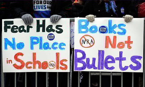 Demonstrators for gun control legislation hold signs in Chicago. (File Photo | AP)