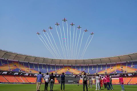 Indian Air Forces (IAF) Surya Kiran Aerobatic Team flies past during rehearsal ahead of the final match between India and Australia, at the Narendra Modi Stadium. (Photo | PTI)