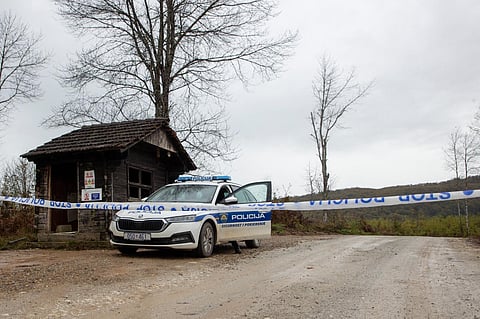 This photograph taken on November 7, 2023 shows a Croatian police car blocking the entrance to Dugi Dol refugees camp close to Croatia/Bosnia border. (Photo | AFP)