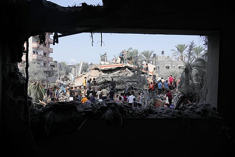 Palestinians look for survivors after the Israeli bombardment of the Gaza Strip in Deir Al-Balah | AP
