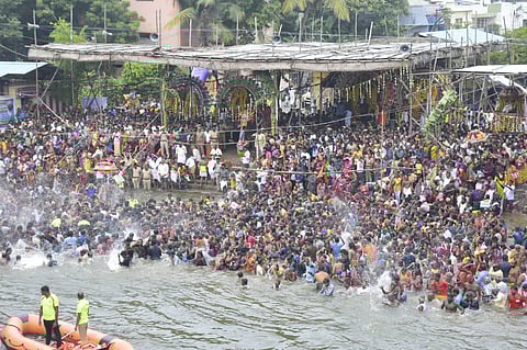 Devotees taking dip in Kaveri Thula Kattam on the Kadaimuga Theerthavari Day of Aippasi Thula Utsavam on Thursday | Express