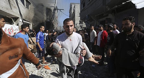 Palestinians rescue survivors after an Israeli strike on Rafah, Gaza Strip. (Photo | AP)