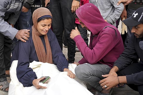 Palestinians mourn relatives killed in the Israeli bombardment of the Gaza Strip in front of the morgue in Deir al Balah, Sunday. (Photo | AP)