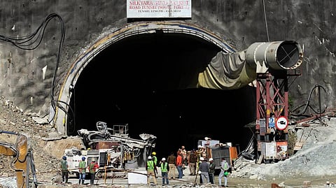 Security personnel and others at the under-construction tunnel between Silkyara and Dandalgaon, days after a portion of the tunnel collapsed trapping several workers inside, in Uttarkashi district. 