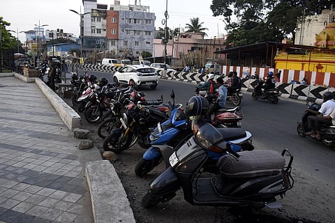 Due to lack of space allocated for vehicle parking facilities, Two wheelers have been parked on the road at Kumaraswamy lake in Coimbatore on Saturday. (Photo | S Senbagapandiyan, EPS)