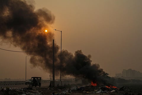 Smoke emanating from burning garbage adds to the air pollution, in Gurugram, on Nov. 2, 2023. (PTI)