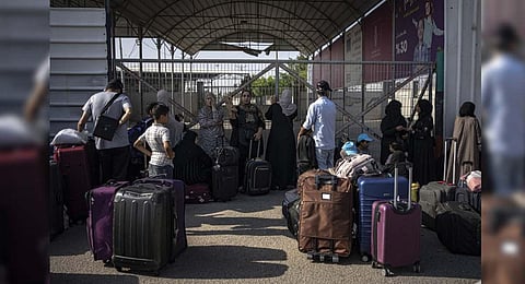 Palestinians wait to cross into Egypt at Rafah, Gaza Strip | AP