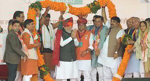 rime Minister Narendra Modi being garlanded during a public meeting ahead of Rajasthan Assembly elections, in Taranagar, Sunday, Nov. 19, 2023. (PTI)
