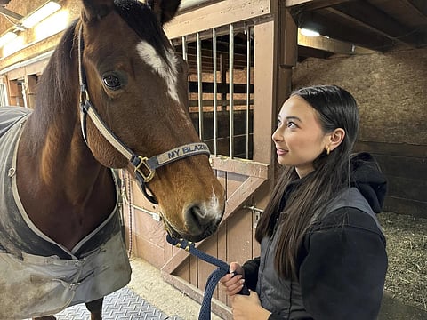 Kylie Ossege looks at her horse, Blaze, at a boarding facility Saturday, Nov 11, 2023. (Photo | AP)