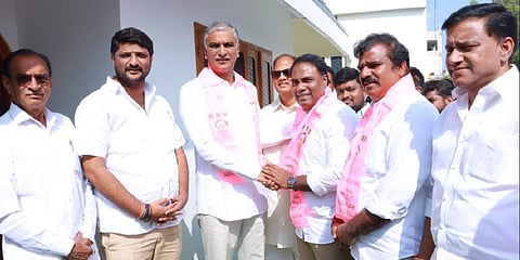 Andole BJP candidate P Babu Mohan’s son Uday Babu Mohan with Finance Minister T Harish Rao (Photo | IANS)