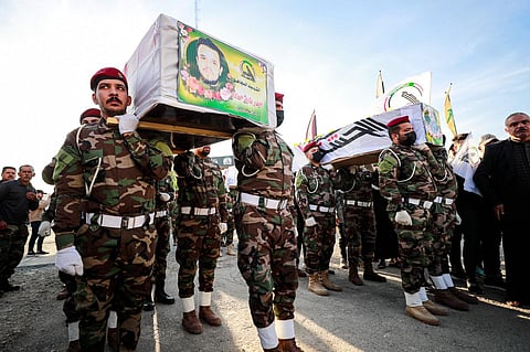 Iraqi soldiers from the Hashed al-Shaabi forces carry the coffins of fighters killed in a US strike earlier in the day, during a funeral in Baghdad on November 22, 2023. (Photo | AFP)