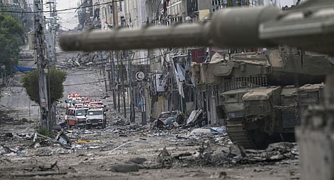Ambulances are seen on a road near an Israeli forces tank during an Israeli army ground operation in the Gaza Strip, Wednesday, Nov. 22, 2023.(Photo | AP)