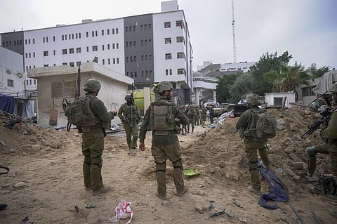Israeli soldiers stand outside Shifa Hospital in Gaza City. (Photo |  AFP)