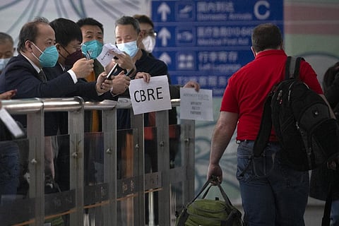 People  wait at the international passenger arrivals area at Beijing Capital Inernational Airport in Beijing. (Photo | AP)