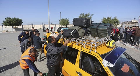 Palestinians stranded in Egypt arrive in the Gaza Strip at Rafah crossing as a temporary ceasefire went into effect Friday, Nov. 24, 2023. (AP Photo)