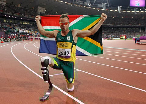 Oscar Pistorius poses with photographs with a national flag after winning gold in the men's 400m - T44 final during the athletics competition at the London 2012 Paralympic Games. (Photo | AFP)