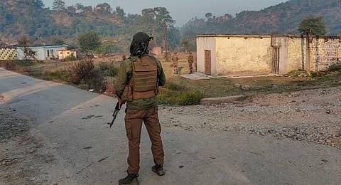 Security personnel stand guard during an encounter with terrorists, at Baji Maal area of Rajouri district, Thursday, Nov. 23, 2023. (PTI)