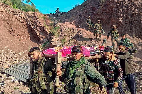 Army personnel and locals carry the body of an army officer near the site of an encounter with terrorists at Kalakote area, in Rajouri district, on Nov. 22, 2023. (PTI)
