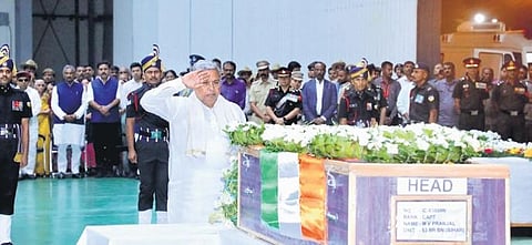 Chief Minister Siddaramaiah pays his last respects to the mortal remains of Captain MV Pranjal in HAL Airport, on Friday. (Photo | Express)