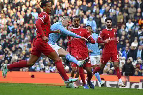 Manchester City's Erling Haaland scores his side's opening goal against Liverpool. (Photo | AP)
