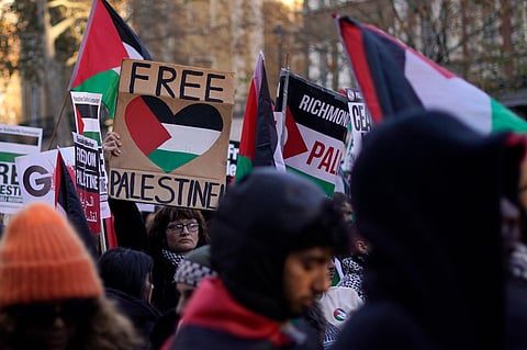 Protesters hold flags and placards as they take part in a pro-Palestinian demonstration as they wend their way along Whitehall in London on Saturday, November 25, 2023. (Photo | AP)