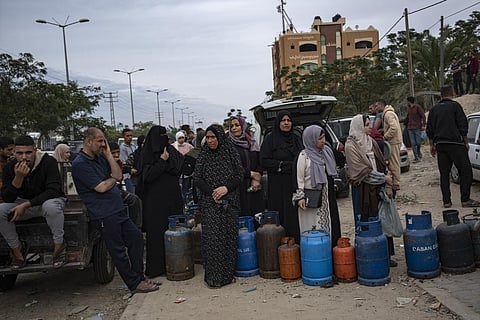 Palestinians line up for cooking gas during the second day of the temporary ceasefire between Hamas and Israel in Khan Younis, Gaza Strip, Saturday, Nov. 25, 2023. (Photo | AP)