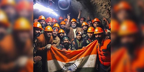 Rescue officials pose for group photos after the successful evacuation of 41 workers from the collapsed Silkyara Tunnel. (Photo | PTI)