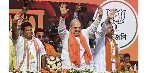 Union Home Minister Amit Shah with West Bengal BJP president Sukanta Majumdar and state Assembly LoP Suvendu Adhikari during a rally. (Photo | PTI)