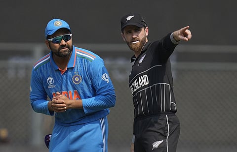 Indian captain Rohit Sharma and New Zealand's captain Kane Williamson talk at the coin toss during the ICC Men's Cricket World Cup first semifinal match between India and New Zealand in Mumbai. Rohit Sharma won the toss and opted to bat first. (Photo | AP
