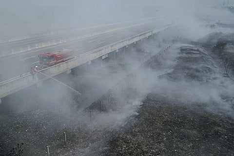 Firefighters attempt to extinguish fire that razes through a landfill in Bekasi, on the outskirts of Jakarta. (Photo | AP)