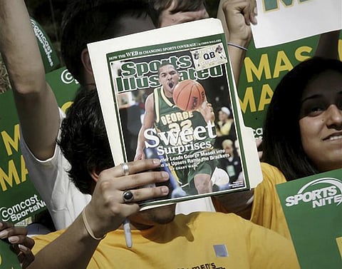 A George Mason University fan holds up a Sports Illustrated magazine at a send off for the team, March 29, 2006. 