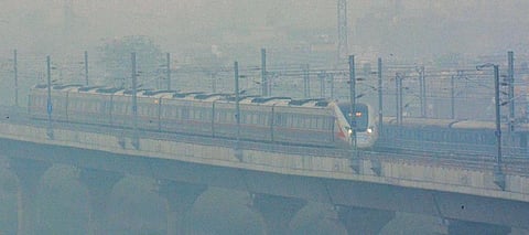 A rapid transit train moves as smoky haze engulfs the elevated corridor in Ghaziabad on Thursday. (Photo | PTI)