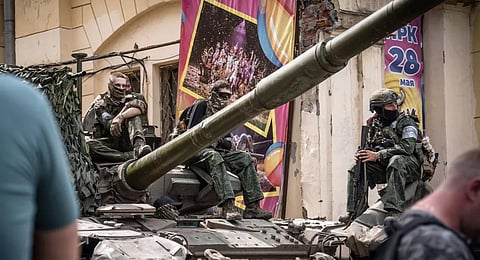 Members of Wagner group sit atop of a tank in a street in the city of Rostov-on-Don, on June 24, 2023.(File Photo | AFP)