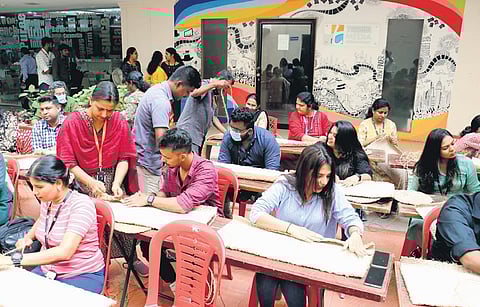The employees of EY GDS engaged in coir grow bags making with training from National Coir Research and Management Institute staff