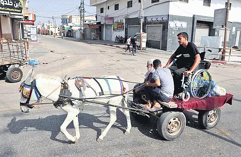 A donkey cart carries Palestinians to a United Nations Relief and Works Agency for Palestine Refugees building. The war in Gaza might add to the numbers. (File Photo | AFP)