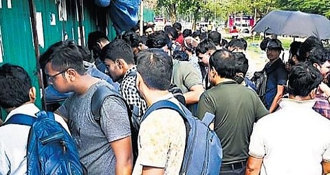 Cricket enthusiasts in front of a ticket counter | Express