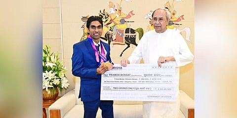 Chief Minister Naveen Patnaik presenting a cheque of Rs 2 crore to Pramod Bhagat | Express