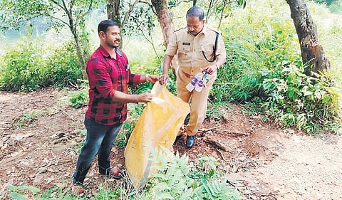 A forest officer collecting plastic waste from Kakki forest area | SHAJI VETTIPURAM