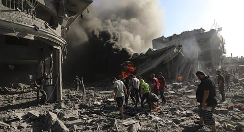 Palestinians inspect the damage of a house destroyed by an Israeli airstrike in Gaza City, Saturday. (Photo | AP)