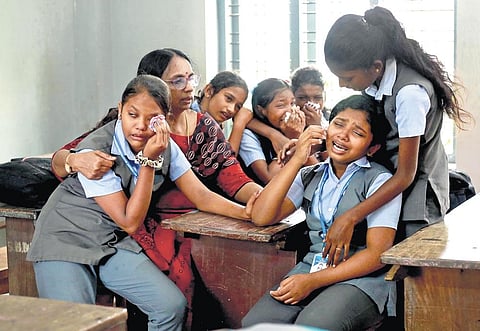 A teacher consoles Libna’s classmates who broke down after paying tributes to their friend at SNDP HSS, Neeliswaram
