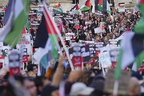 Protesters hold placards and Palestinian flags during a pro-Palestinian rally in Trafalgar Square, London, Saturday Nov. 4. (Photo | AP)