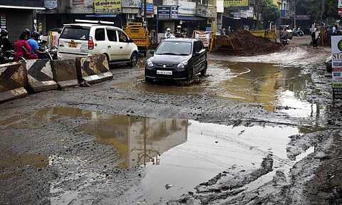 Vehicles passing on the slushy Podanur road in Coimbatore after heavy rain. (Photo | S Senbagapandiyan)