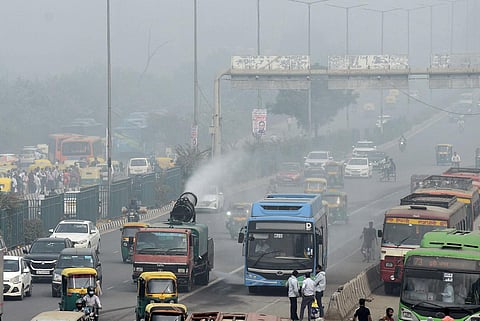 Anti-smog guns being used to spray water droplets to curb air pollution, in New Delhi.