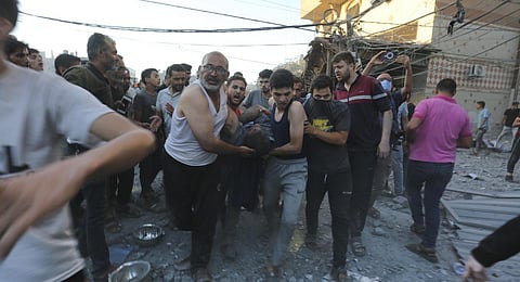 Palestinians evacuate survivors after an Israeli strike on the Gaza Strip in Rafah on Monday, Nov. 6, 2023. (AP Photo)