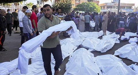 Palestinians mourn relatives killed in the Israeli bombardment of the Gaza Strip in front of the morgue in Deir al Balah, Monday, Nov. 6, 2023.(Photo | AP)