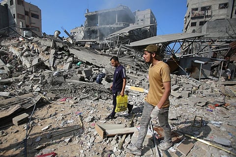 Palestinians inspect the damage in Gaza City's Shati refugee camp on November 6. (Photo | AFP)