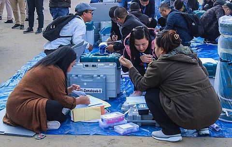 Polling officials collect EVMs and other election material at a distribution centre ahead of voting for Mizoram Assembly elections. (Photo | PTI)