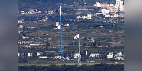 Flags of North Korea (rear) and South Korea (front) flutter in the wind anear the border area between two Koreas in Paju, South Korea (Photo | AP)