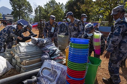Policemen pack relief material to distribute among earthquake survivors in Jajarkot District, northwestern Nepal. (Photo | AP)
